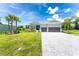 Two-story home with a gray exterior, landscaping, and a paved driveway at 9973 Calumet Blvd, Port Charlotte, FL 33981