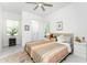 Spacious bedroom with a cozy bed, ceiling fan, and plenty of natural light at 9973 Calumet Blvd, Port Charlotte, FL 33981