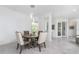 Bright dining room with a round table and four chairs, near kitchen at 9973 Calumet Blvd, Port Charlotte, FL 33981
