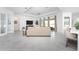 Open concept living room with sectional sofa, large windows, and ceiling fan at 9973 Calumet Blvd, Port Charlotte, FL 33981