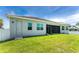 Landscaped backyard with spacious lawn and privacy fence at 9973 Calumet Blvd, Port Charlotte, FL 33981
