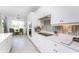 Modern white kitchen with stainless steel appliances at 9973 Calumet Blvd, Port Charlotte, FL 33981