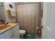 Clean bathroom with a shower/tub combination and a seashell-themed shower curtain at 860 Columbia St, Port Charlotte, FL 33948