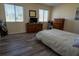 Bright and airy bedroom with wood-look floors, dresser, and large bed at 860 Columbia St, Port Charlotte, FL 33948