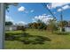 Overgrown backyard with large grassy area at 860 Columbia St, Port Charlotte, FL 33948