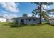 Large backyard with grassy area and basketball hoop at 860 Columbia St, Port Charlotte, FL 33948