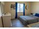 Bedroom with a double bed, dresser and blue curtains at 860 Columbia St, Port Charlotte, FL 33948