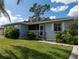 House exterior featuring a light blue color and landscaping at 860 Columbia St, Port Charlotte, FL 33948