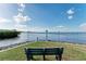 Peaceful waterfront view with a bench for relaxation at 1250 W Marion Ave # 141, Punta Gorda, FL 33950