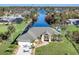 Single-Gathering home on canal with fenced yard, driveway, and lush landscaping at 18404 Lake Worth Blvd, Port Charlotte, FL 33948