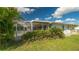 Landscaped backyard with screened patio and pool at 22465 Vale Ave, Punta Gorda, FL 33980