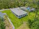 Aerial view showcasing a house with an expansive yard and nearby lush greenery at 2404 Hanford Ln, North Port, FL 34288