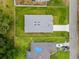 Aerial view of new construction home, highlighting the roof, large yard, and proximity to other houses at 2404 Hanford Ln, North Port, FL 34288