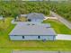 Aerial shot shows a home with large yard, gray roof and proximity to nearby green space at 2404 Hanford Ln, North Port, FL 34288