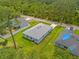 Aerial view of a home with a gray roof, a large backyard and a new fence at 2404 Hanford Ln, North Port, FL 34288