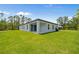 Spacious backyard with lush grass and a covered patio, perfect for outdoor entertaining at 2404 Hanford Ln, North Port, FL 34288
