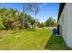 Expansive backyard featuring lush greenery and a well-maintained lawn, perfect for outdoor activities and relaxation at 2404 Hanford Ln, North Port, FL 34288