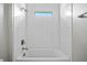 Bright bathroom featuring white subway tile and a window above the tub at 2404 Hanford Ln, North Port, FL 34288