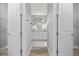 View through open double doors to a dual sink vanity and walk-in closet with wire shelving at 2404 Hanford Ln, North Port, FL 34288
