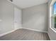 Bedroom with closet, window, neutral walls, and light-colored laminate flooring at 2404 Hanford Ln, North Port, FL 34288