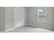 Bedroom with closet, window, neutral walls, and light-colored laminate flooring at 2404 Hanford Ln, North Port, FL 34288