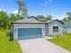 Beautiful single-story home showcasing a well-kept lawn and a striking blue garage door for curb appeal at 2404 Hanford Ln, North Port, FL 34288
