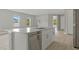 This kitchen has an island with a sink and dishwasher, as well as stainless steel appliances at 2404 Hanford Ln, North Port, FL 34288
