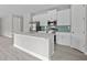 This kitchen boasts white cabinets, stainless steel appliances, and a stylish island at 2404 Hanford Ln, North Port, FL 34288