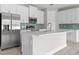 A kitchen featuring white cabinets, stainless steel appliances, and a breakfast bar at 2404 Hanford Ln, North Port, FL 34288