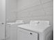 Laundry room with new washer and dryer and wire shelving at 2404 Hanford Ln, North Port, FL 34288