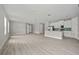 Bright living room with luxury vinyl plank floors, and a modern kitchen with stainless steel appliances at 2404 Hanford Ln, North Port, FL 34288