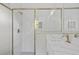 Elegant white tile shower with modern fixtures and glass door at 2404 Hanford Ln, North Port, FL 34288