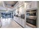 Bright kitchen with white cabinets, granite countertops, and stainless steel appliances at 2868 Coral Way, Punta Gorda, FL 33950