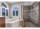 Relaxing bathroom with a corner soaking tub and a frameless glass shower at 2868 Coral Way, Punta Gorda, FL 33950