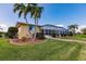 Landscaped backyard with palm trees, pool, and screened enclosure at 2868 Coral Way, Punta Gorda, FL 33950
