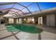 Tranquil pool and patio at dusk, screened for privacy at 2868 Coral Way, Punta Gorda, FL 33950