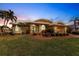 Stunning home exterior at dusk, featuring beautiful landscaping at 2868 Coral Way, Punta Gorda, FL 33950