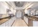 Modern kitchen featuring white cabinets, granite countertops, and stainless steel appliances at 2868 Coral Way, Punta Gorda, FL 33950