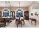 Elegant dining room with dark wood furniture and arched windows at 2868 Coral Way, Punta Gorda, FL 33950
