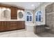 Elegant bathroom with double sinks, soaking tub, and a walk-in shower at 2868 Coral Way, Punta Gorda, FL 33950