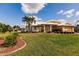 Single-story house with a well-manicured lawn and palm trees at 2868 Coral Way, Punta Gorda, FL 33950