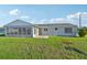 Large backyard with grassy area and screened patio at 8109 San Jacinto Ave, North Port, FL 34287