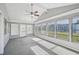 Spacious sunroom with built-in shelving and a ceiling fan at 8109 San Jacinto Ave, North Port, FL 34287