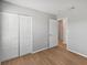 Bedroom with double mirrored closet doors and wood-look floors at 8109 San Jacinto Ave, North Port, FL 34287
