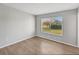 Spacious bedroom with large window and wood-look floors at 8109 San Jacinto Ave, North Port, FL 34287