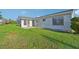 Home's backyard with grassy lawn and screened enclosure at 8109 San Jacinto Ave, North Port, FL 34287