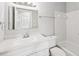 Clean bathroom with white vanity, tub, and tiled walls at 8109 San Jacinto Ave, North Port, FL 34287