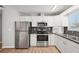 Modern kitchen with stainless steel appliances and white cabinets at 8109 San Jacinto Ave, North Port, FL 34287