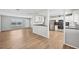 Living area with wood-look floors and open concept kitchen at 8109 San Jacinto Ave, North Port, FL 34287