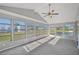 Relaxing sunroom with ceiling fan, grey carpet, and ample natural light at 8109 San Jacinto Ave, North Port, FL 34287